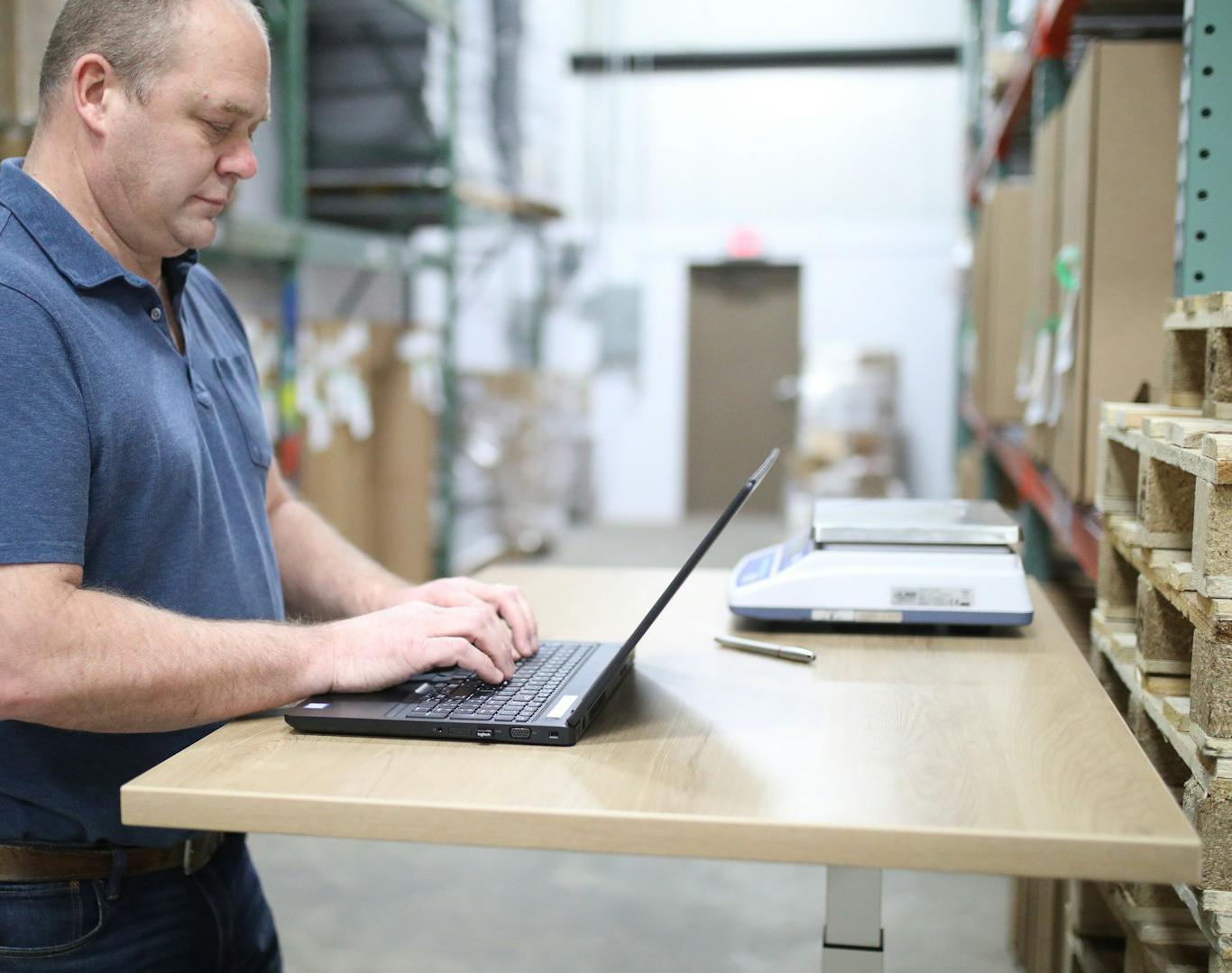 Fulfillment staff preparing packages in a well-organized warehouse.